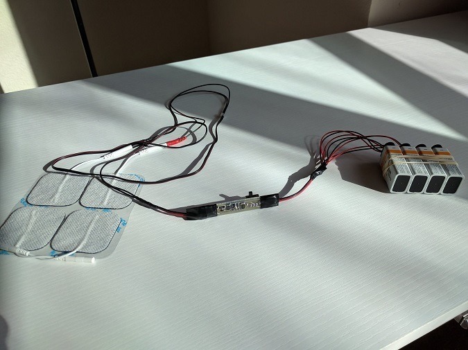 -- DIY tDCS device: Four 9-volt batteries and sticky self-adhesive electrodes, connected by a circuit board. Courtesy of Matt Herich